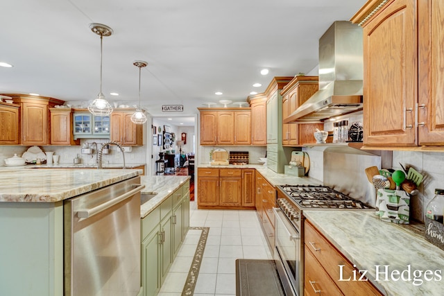 kitchen featuring decorative backsplash, appliances with stainless steel finishes, wall chimney exhaust hood, light tile patterned floors, and decorative light fixtures