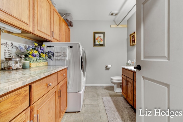 laundry room with washing machine and dryer and light tile patterned flooring