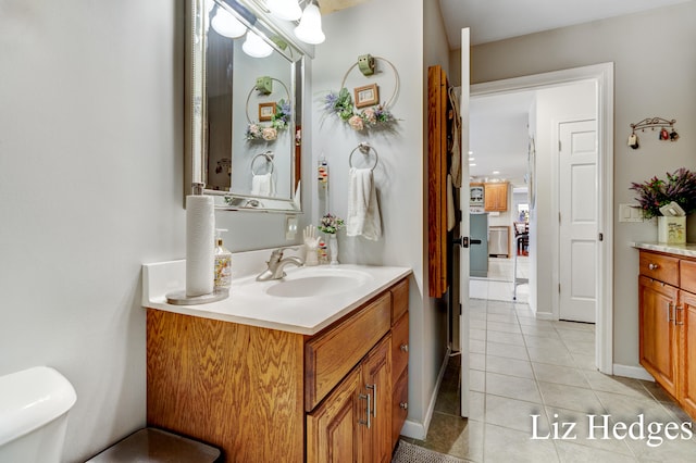 bathroom featuring tile patterned flooring, vanity, and toilet