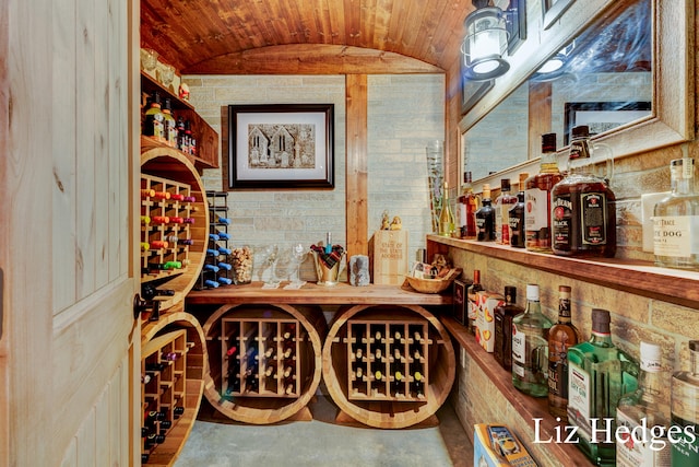 wine room with vaulted ceiling