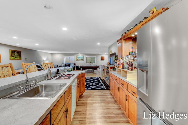 kitchen with stainless steel fridge, sink, light hardwood / wood-style flooring, dishwasher, and pool table