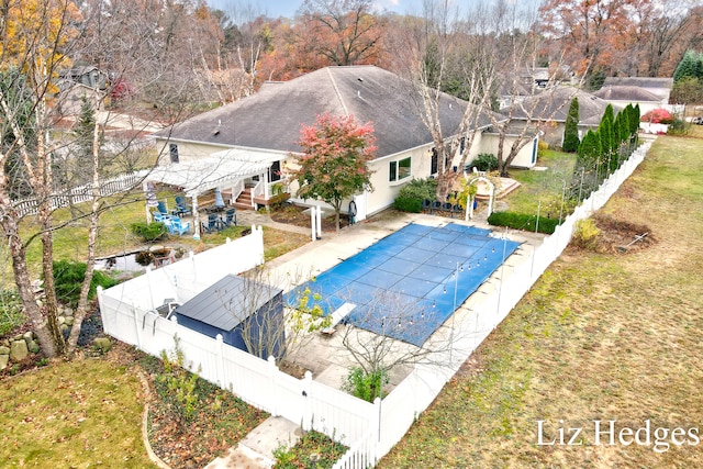 view of pool featuring a lawn and a patio