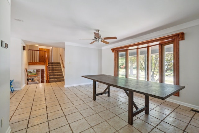 unfurnished dining area featuring ceiling fan and light tile patterned floors