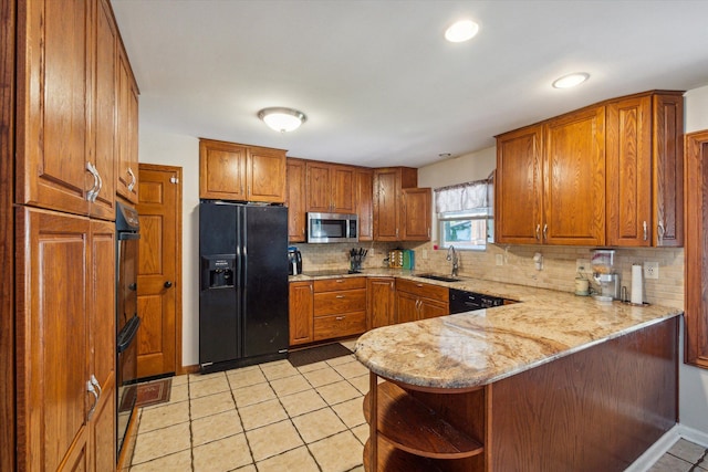 kitchen with kitchen peninsula, backsplash, sink, black appliances, and light tile patterned flooring