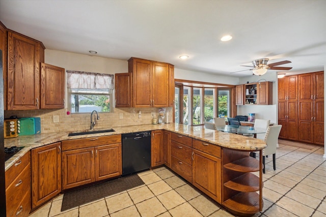 kitchen featuring kitchen peninsula, black dishwasher, a healthy amount of sunlight, and sink