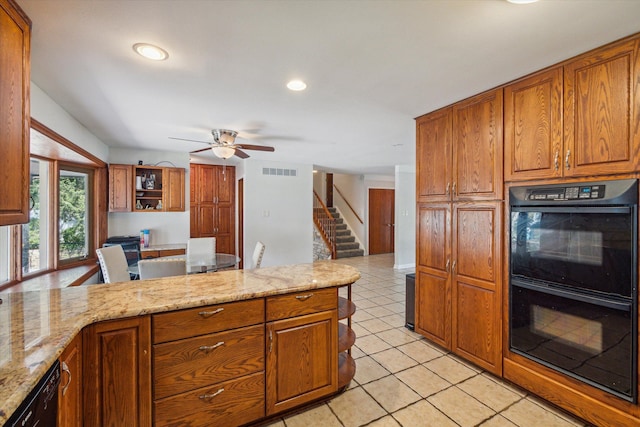 kitchen featuring black appliances, ceiling fan, light stone countertops, and light tile patterned floors