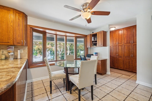 dining space with ceiling fan, a healthy amount of sunlight, and light tile patterned flooring