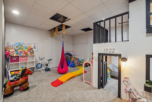 playroom featuring a paneled ceiling and carpet