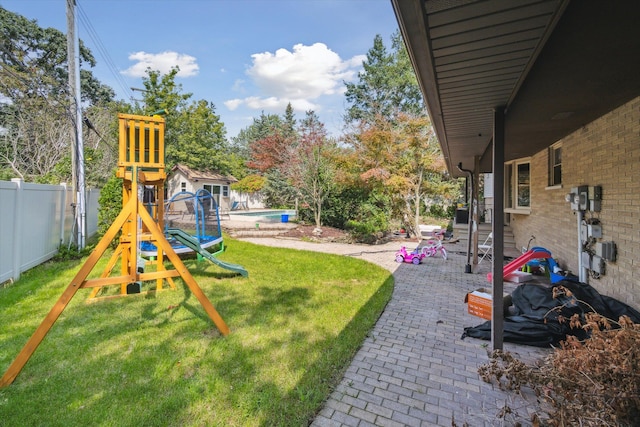 view of yard featuring a playground and a patio area