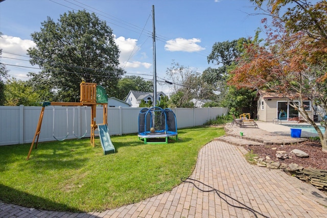 view of yard with a playground, a patio area, a trampoline, and a storage shed