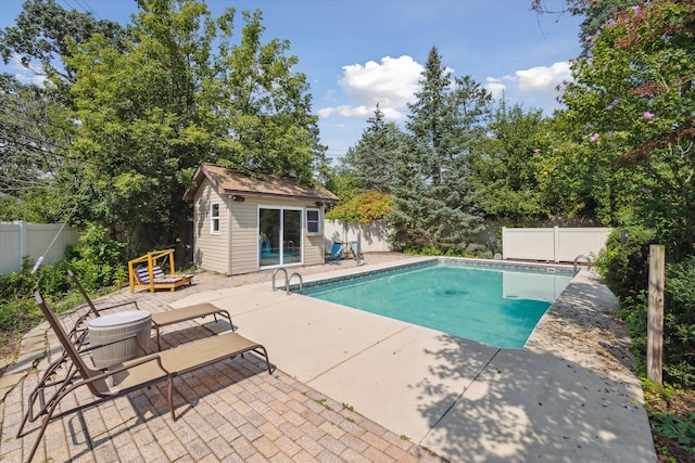 view of swimming pool with an outbuilding and a patio area