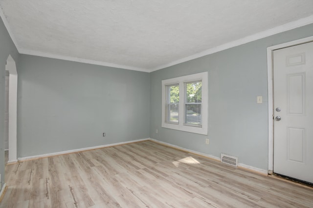 unfurnished room featuring light hardwood / wood-style flooring, a textured ceiling, and ornamental molding