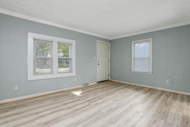 unfurnished room with crown molding and light hardwood / wood-style floors