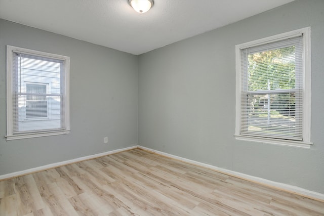 spare room with plenty of natural light and light wood-type flooring