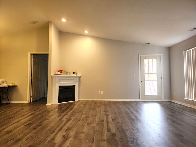 unfurnished living room with dark hardwood / wood-style flooring and vaulted ceiling