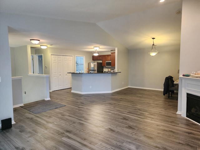 unfurnished living room featuring dark hardwood / wood-style flooring and lofted ceiling