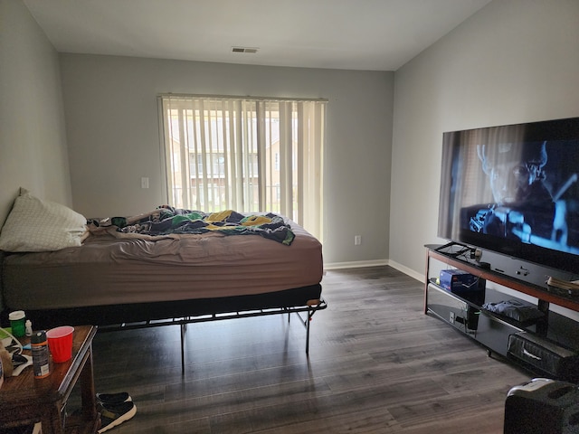 bedroom with hardwood / wood-style flooring