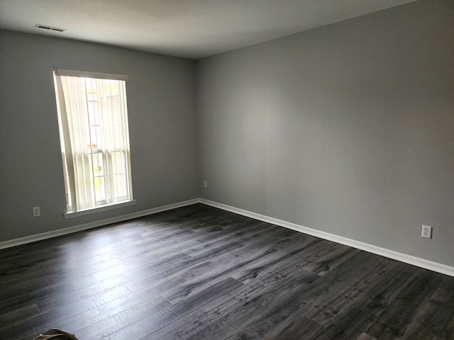 unfurnished room with dark hardwood / wood-style floors