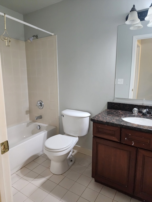 full bathroom featuring tile patterned floors, vanity, toilet, and washtub / shower combination