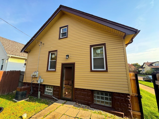 back of house featuring cooling unit