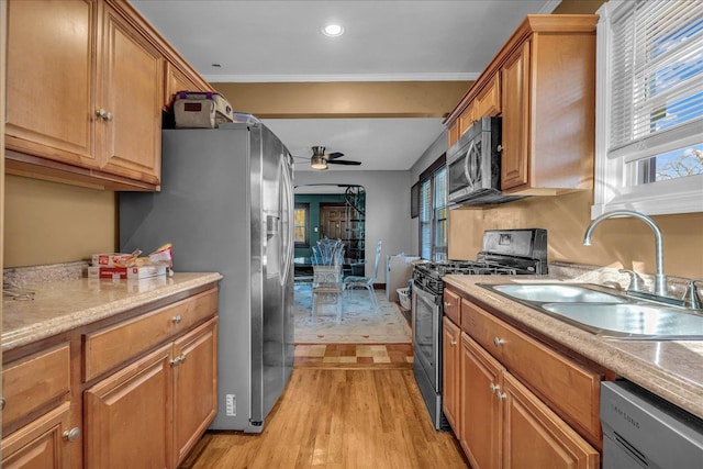 1449 Wayburn St, Grosse Pointe, MI 48230 - kitchen with a sink, stainless steel appliances, light countertops, light wood-type flooring, and a ceiling fan