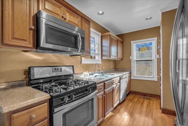 1449 Wayburn St, Grosse Pointe, MI 48230 - kitchen with a sink, light wood-style floors, stainless steel appliances, baseboards, and ornamental molding