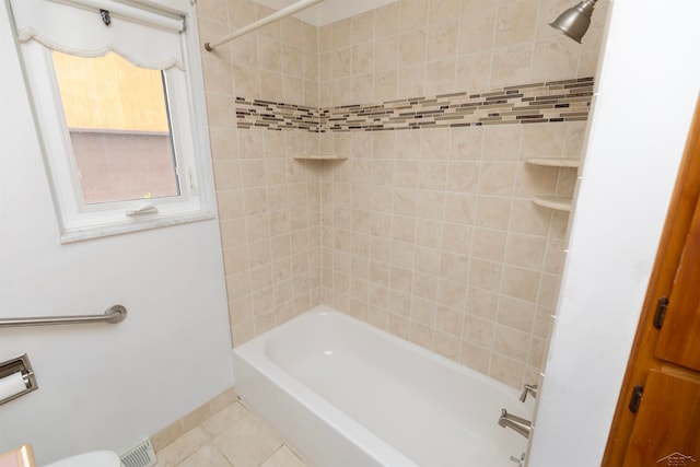 bathroom featuring tiled shower / bath combo and tile patterned floors