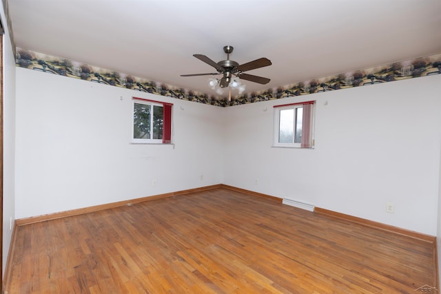 unfurnished room with hardwood / wood-style floors and ceiling fan