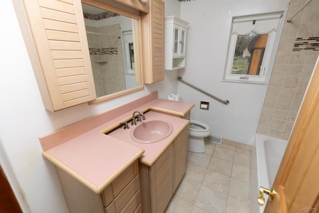 full bathroom featuring toilet, vanity, tile patterned floors, and tiled shower / bath