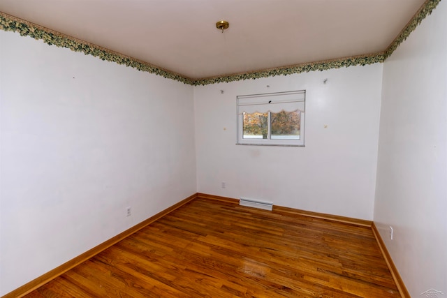 spare room with hardwood / wood-style floors