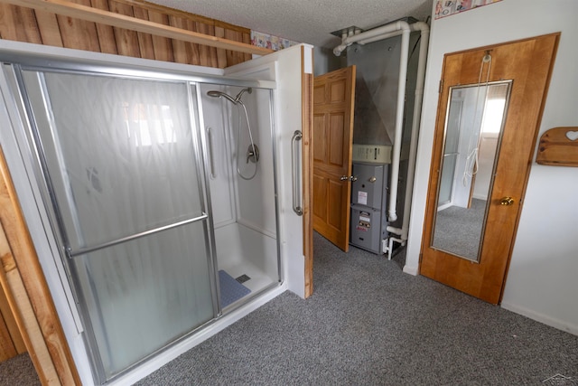 bathroom featuring a shower with shower door and a textured ceiling