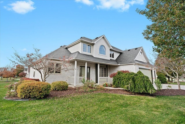 view of front of house with a garage, a porch, and a front yard