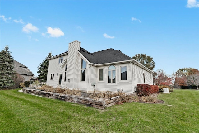 rear view of property with a yard