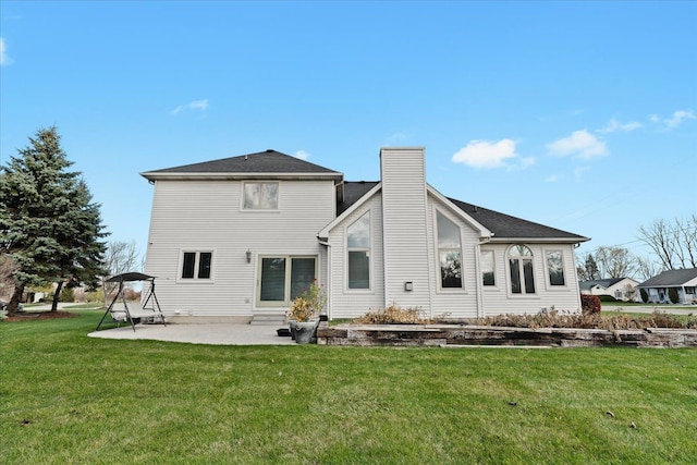 back of house featuring a patio area and a yard