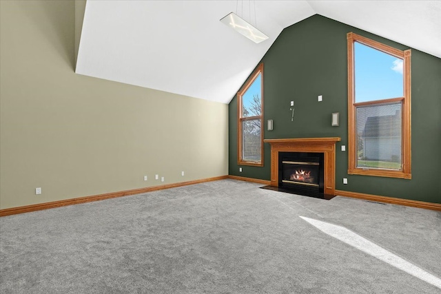 unfurnished living room featuring light colored carpet, vaulted ceiling, and plenty of natural light