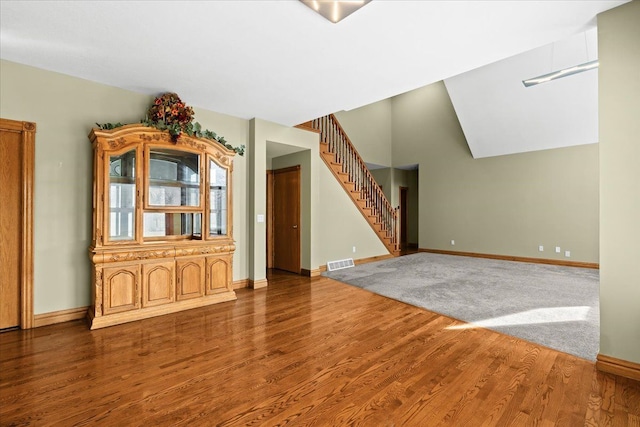 interior space with vaulted ceiling and hardwood / wood-style flooring