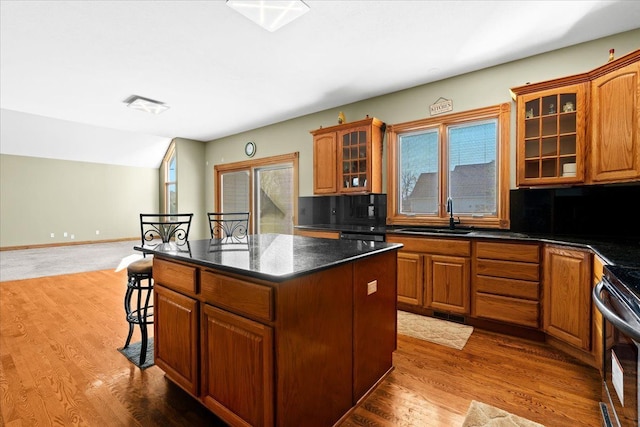 kitchen with decorative backsplash, wood-type flooring, and a center island