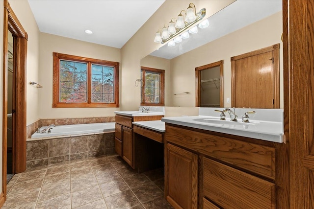 bathroom with vanity, tiled bath, and tile patterned floors