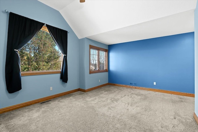 empty room with carpet and lofted ceiling