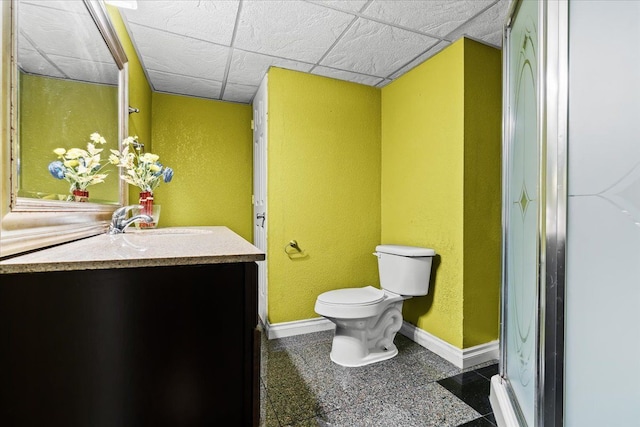 bathroom with vanity, toilet, and a paneled ceiling