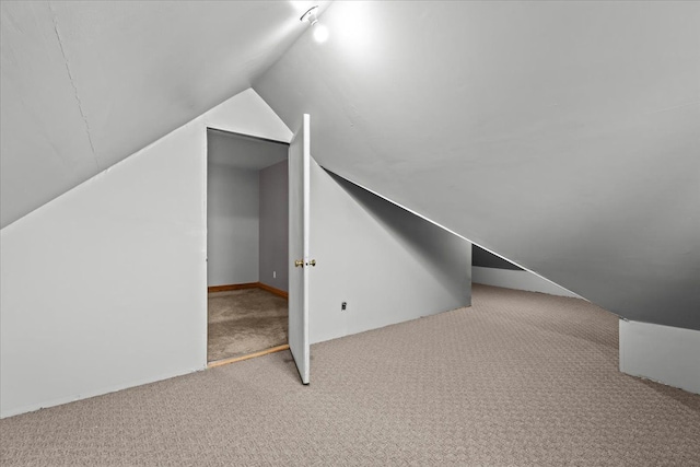 bonus room with carpet flooring and lofted ceiling