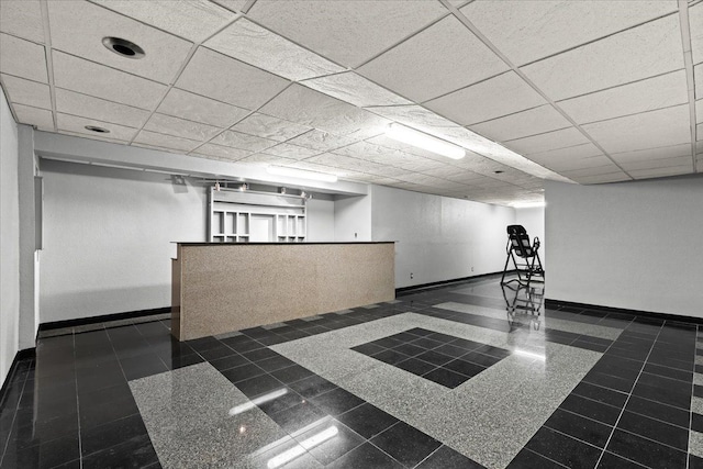 basement featuring a paneled ceiling