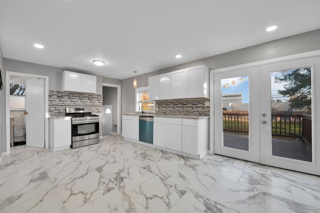 kitchen with decorative backsplash, french doors, stainless steel appliances, decorative light fixtures, and white cabinets