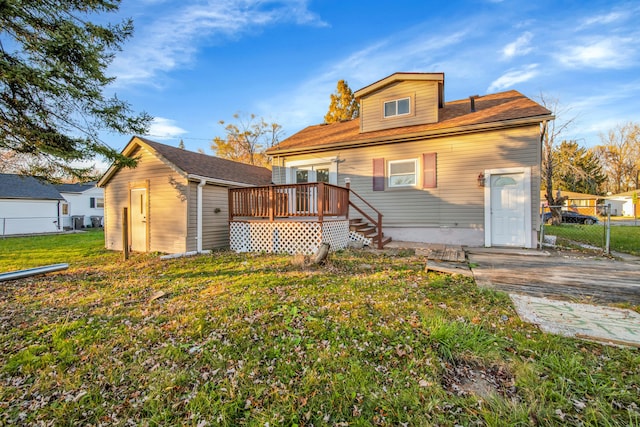 back of property featuring a lawn and an outbuilding