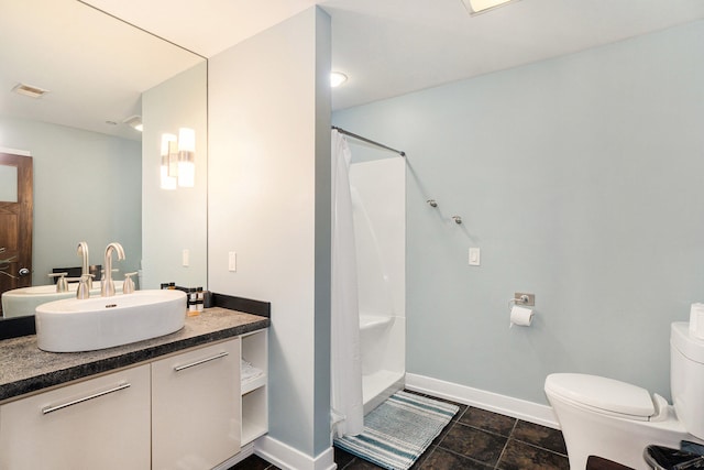 bathroom with vanity, toilet, and walk in shower