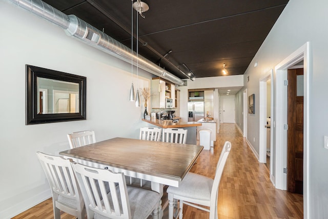 dining area with light hardwood / wood-style floors