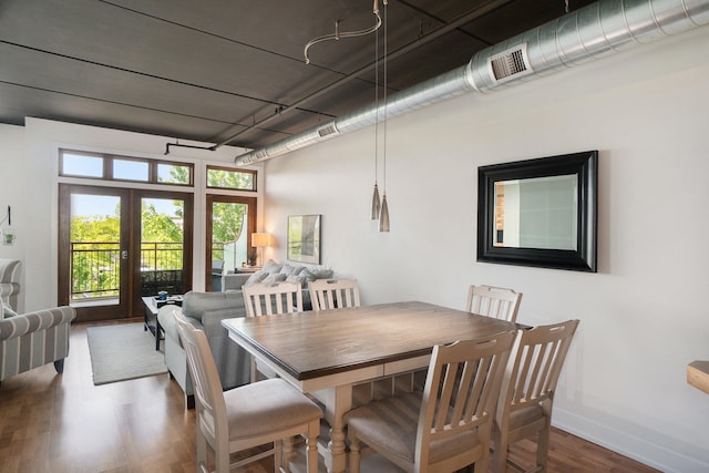 dining space featuring hardwood / wood-style floors and french doors