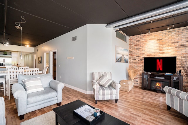 living room with hardwood / wood-style floors and track lighting