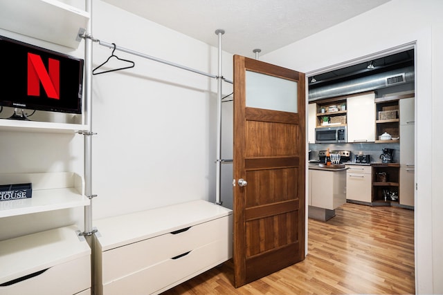 walk in closet featuring light wood-type flooring