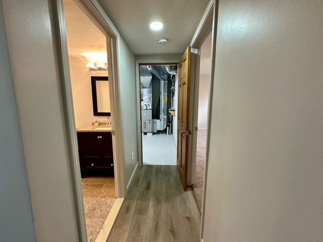 corridor with light hardwood / wood-style floors